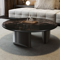 Simple round supercrystalline stone coffee table by Creature B Comforts