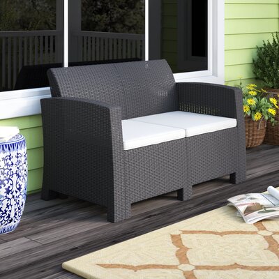 Alderman Faux Rattan Loveseat with All-Weather Cushions by Beachcrest Home