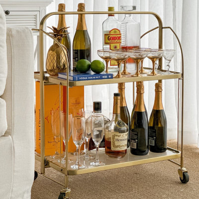 Modern & Stylish Gold and Fluted Addlie Glass Bar Cart by Everly Quinn