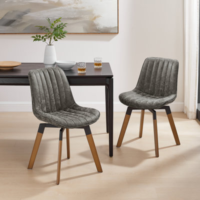 Bishaan Tufted Faux Leather Upholstered Swivel Dining Side Chair by Wade Logan