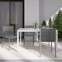 4-Person Patio Dining Set with White Rectangular Table, Stackable Polypropylene Armchairs for Indoor/Outdoor Use by Hokku Designs