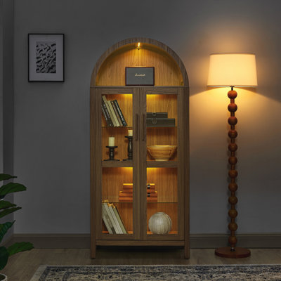 A high arched storage cabinet with a lamp, a modern retro-style storage cabinet with adjustable glass partitions, suitable for use as a multi-function by Red Barrel Studio